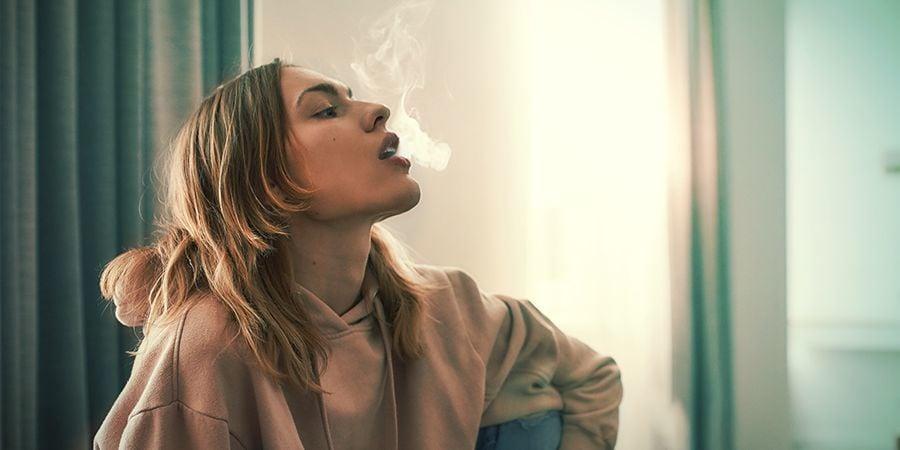 Girl exhaling smoke