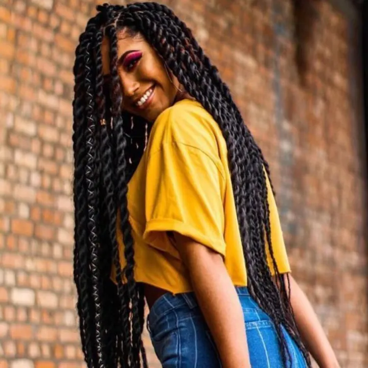 Picture showing a lady rocking her waist length cuban  hairdo