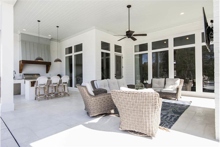Image of a spacious covered patio with outdoor kitchen, breakfast bar, and sitting area