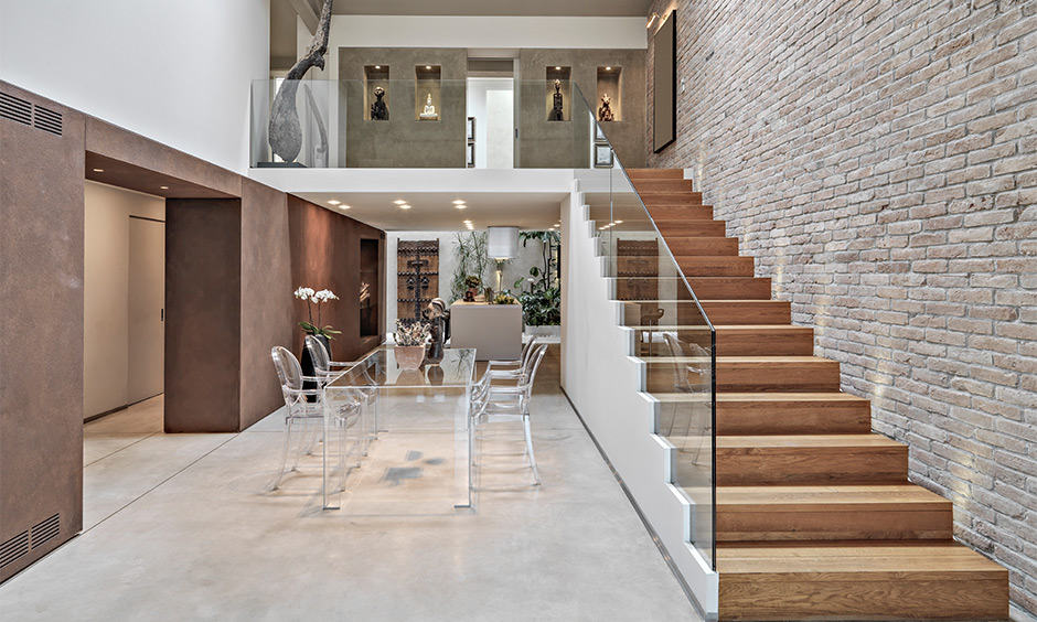 Exposed Brick Staircase Wall Design with glass staircase railing