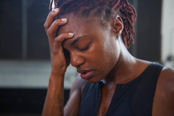 portrait of frustrated black woman sweating - black woman stress stock pictures, royalty-free photos & images