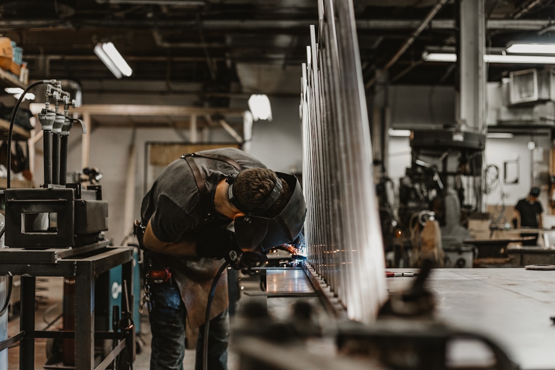 A technician performs routine equipment maintenance in a manufacturing facility, ensuring smooth operations and optimal functionality.