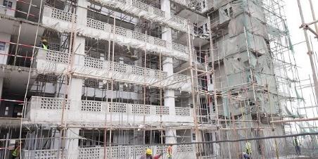 A building under construction with scaffolding

Description automatically generated