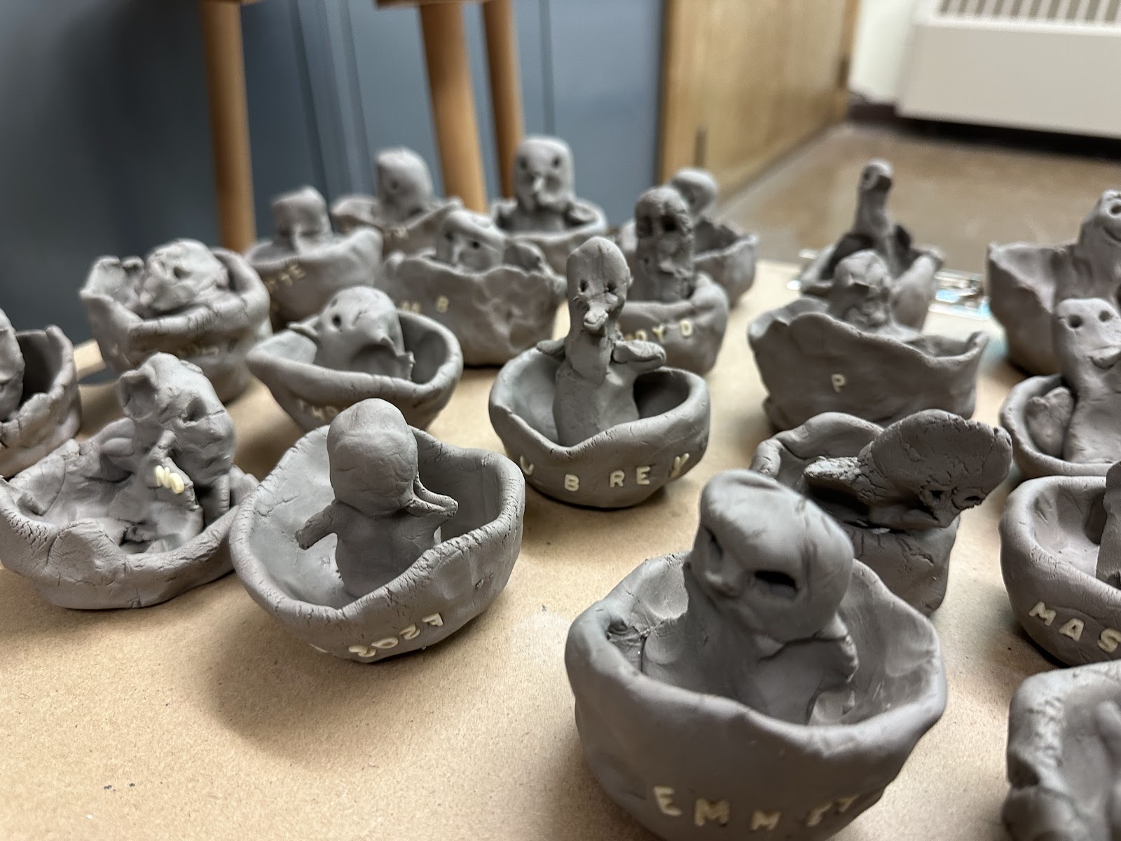 image of student made clay penguins