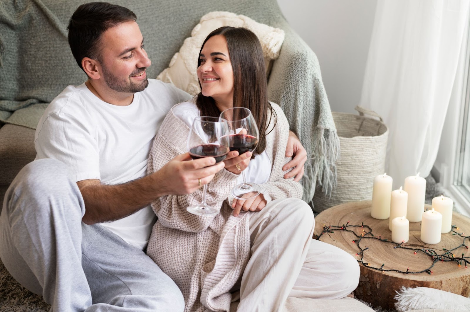 a couple enjoying a glass of red wine