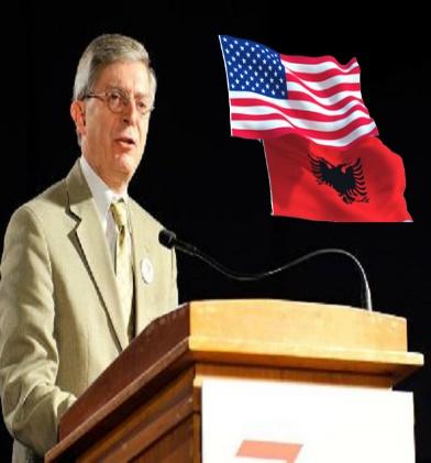 A person standing at a podium with a flag behind him Description automatically generated with medium confidence