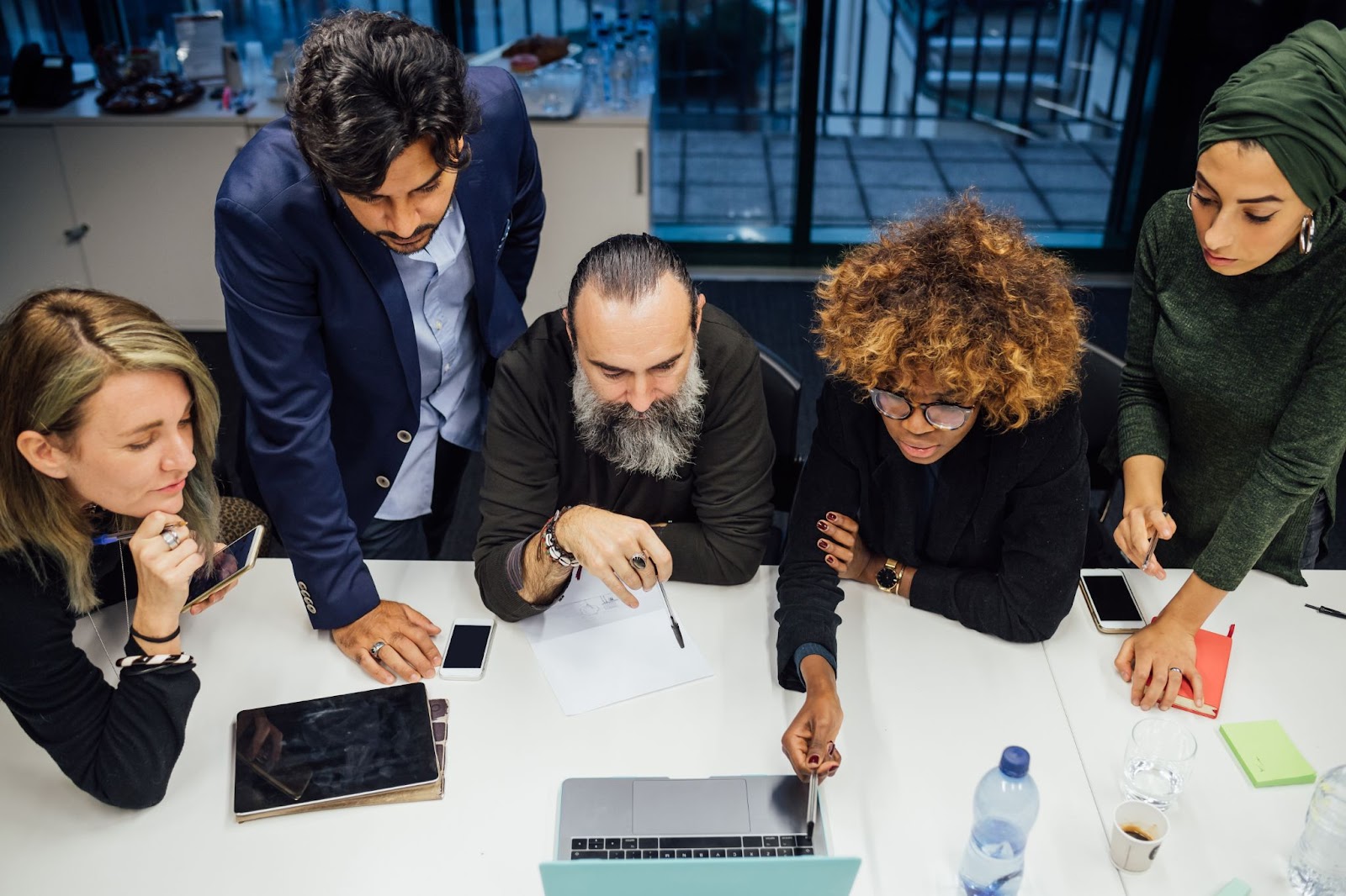 Business partners are brainstorming in a room. 