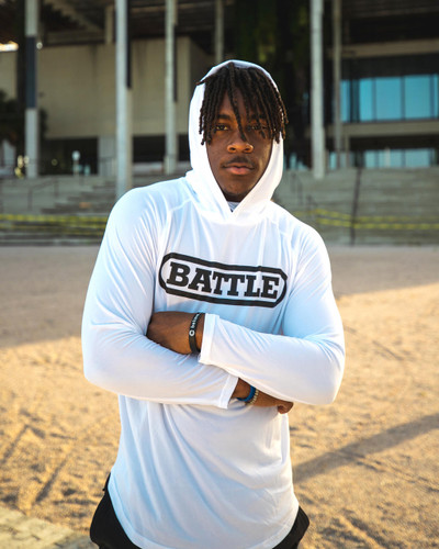 Male athlete wearing white Battle Light Action Hoodie to school