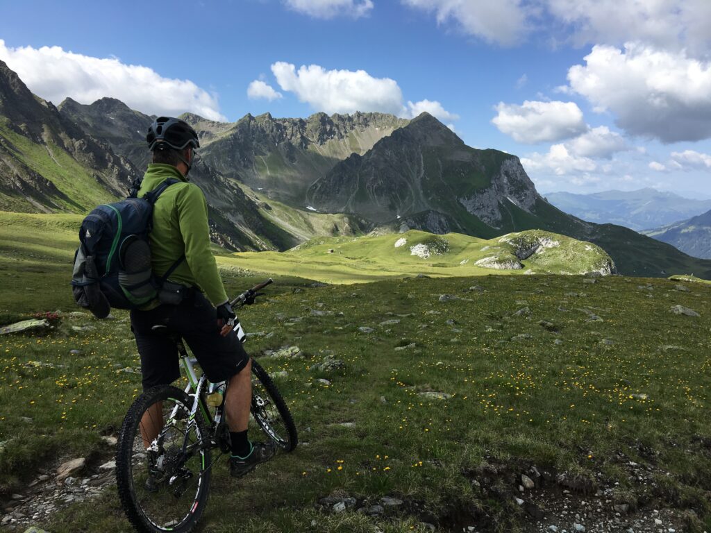A man on a bike staring at a mountain