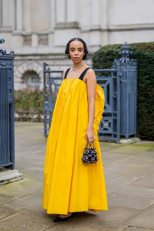 Picture showing an attendee rocking the a yellow dress for LFW