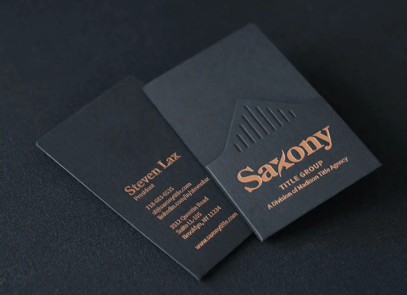 A business card with embossed lettering.
