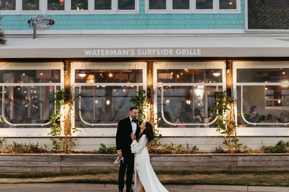 Couple embracing at their wedding outside of the Attic at Waterman’s