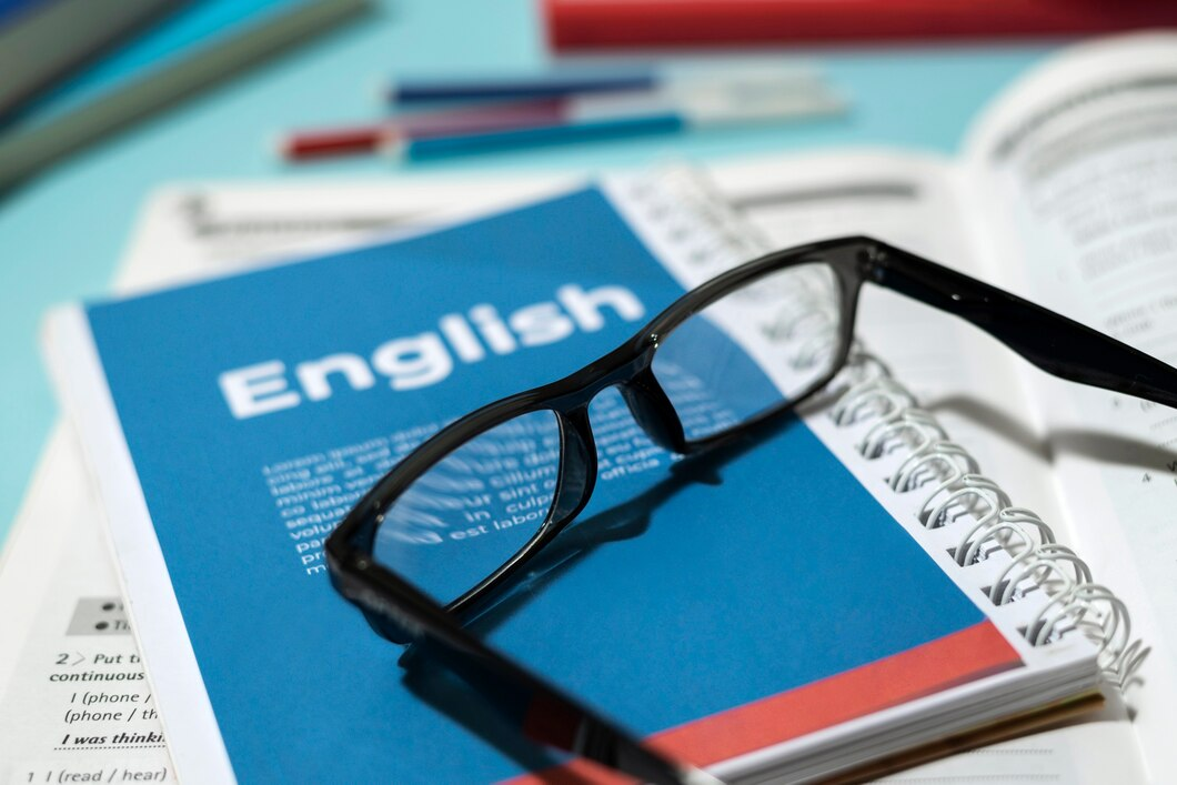 An English book with reading glasses on a stylish table, symbolising focused revision.