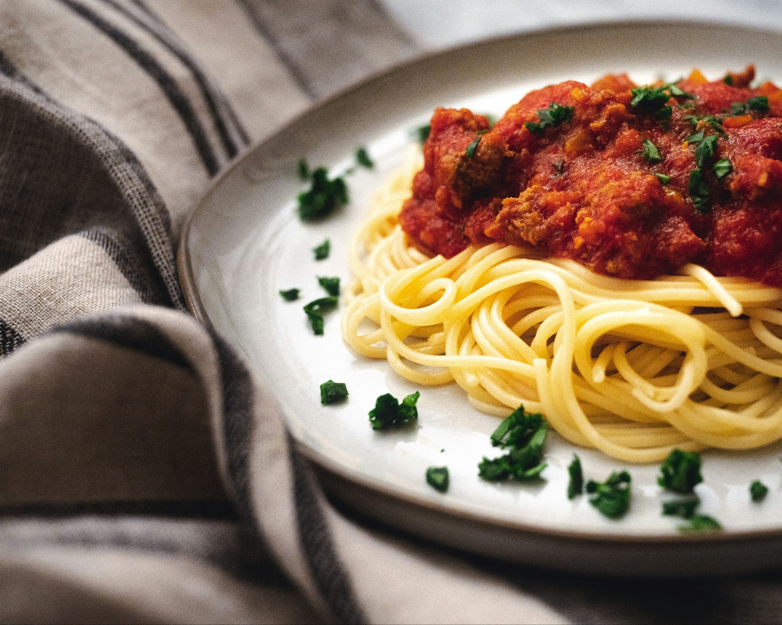 A beautiful plate of Spaghetti bolognese with tangy tomato sauce is a classic dish in Italy.  