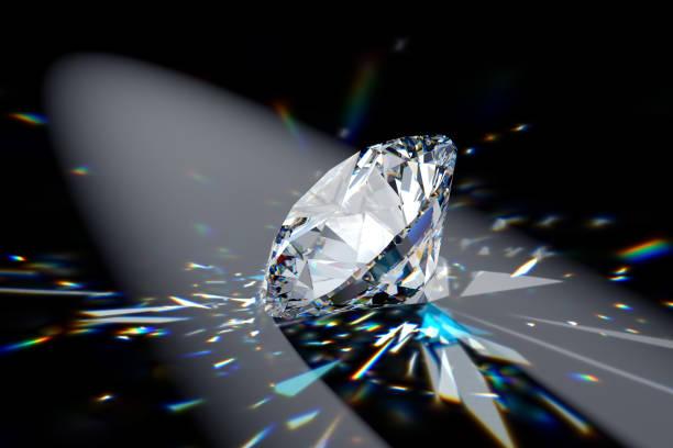 Round brilliant diamond in spotlight with colorful refraction rays. Round brilliant cut diamond in a spotlight on black background with contrast shadows and colorful refraction rays of light diamond stock pictures, royalty-free photos & images
