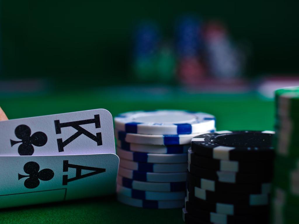 A pair of cards and poker chips

Description automatically generated