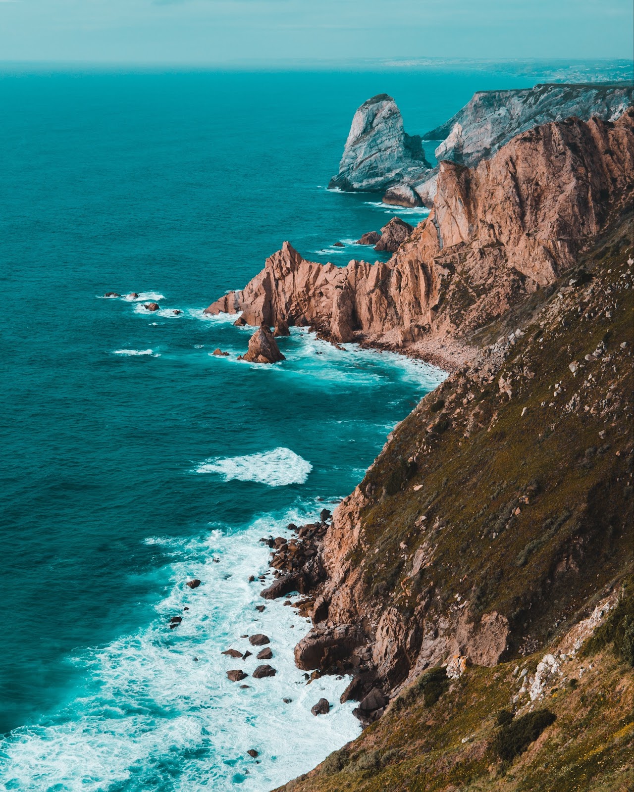 The scenic Atlantic coastline near Cascais with dramatic cliffs.

