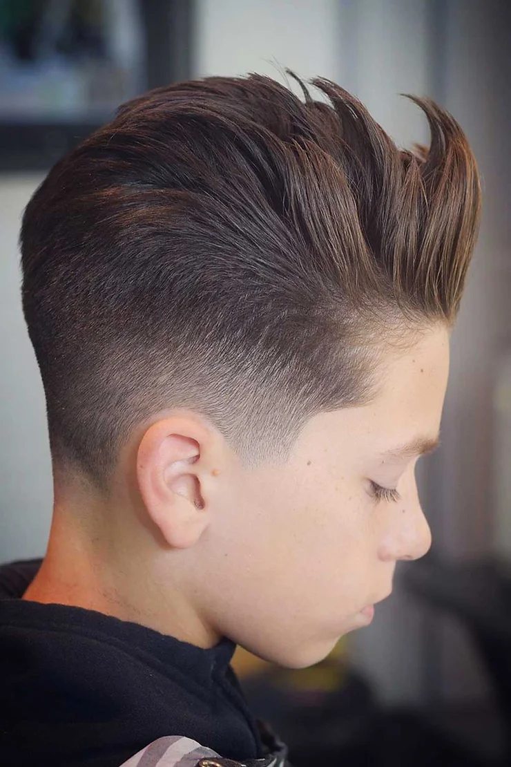 Side view of a boy rocking the short sides and long on top 