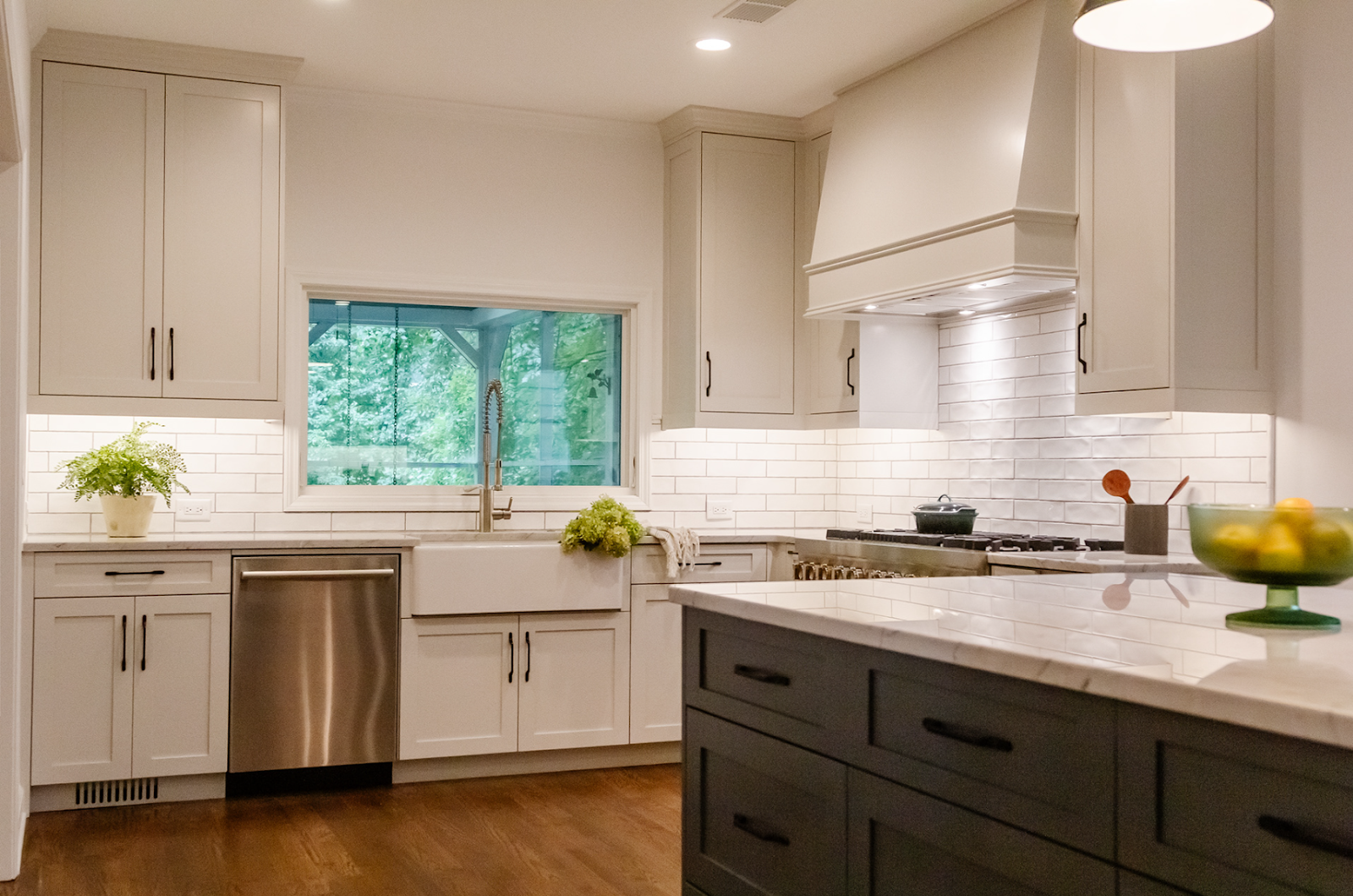 Kitchen renovation (featuring new countertops, cabinetry, and range hood) at this Atlanta home