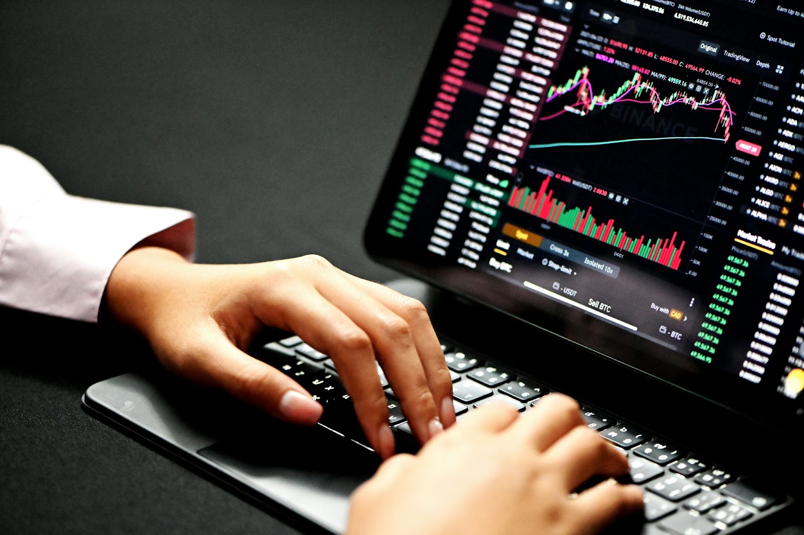 A person with a computer doing trading in the stock exchange