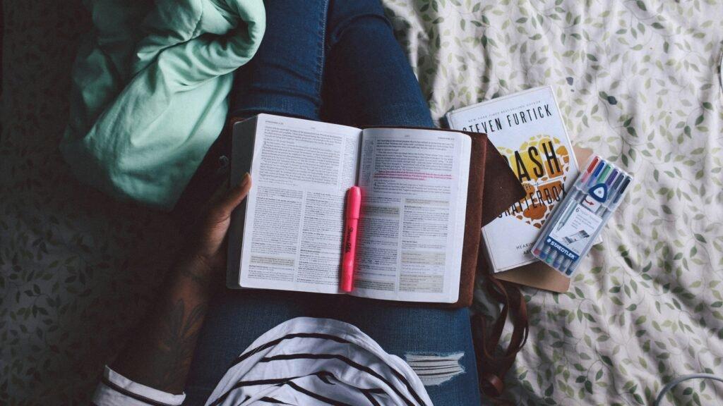 man with a book on his lap - How To Improve Study Habits