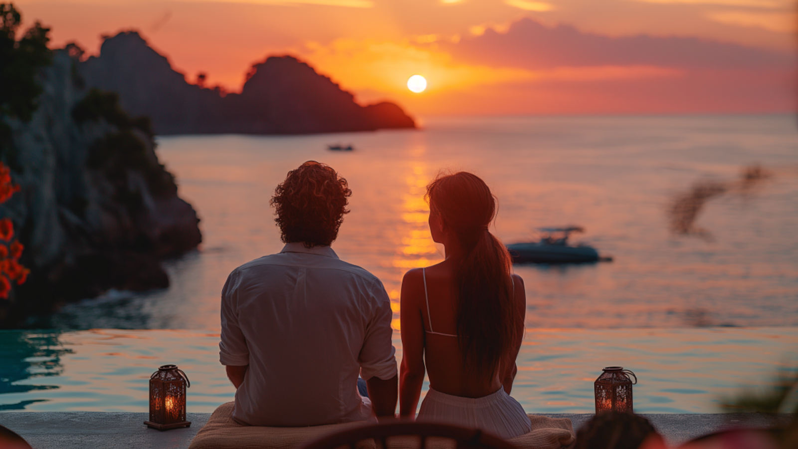 A couple enjoying a romantic sunset from their private villa in Croatia overlooking the sea.