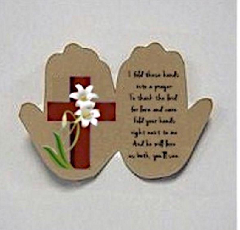 A paper cut out of a hand with a cross and a flower

Description automatically generated