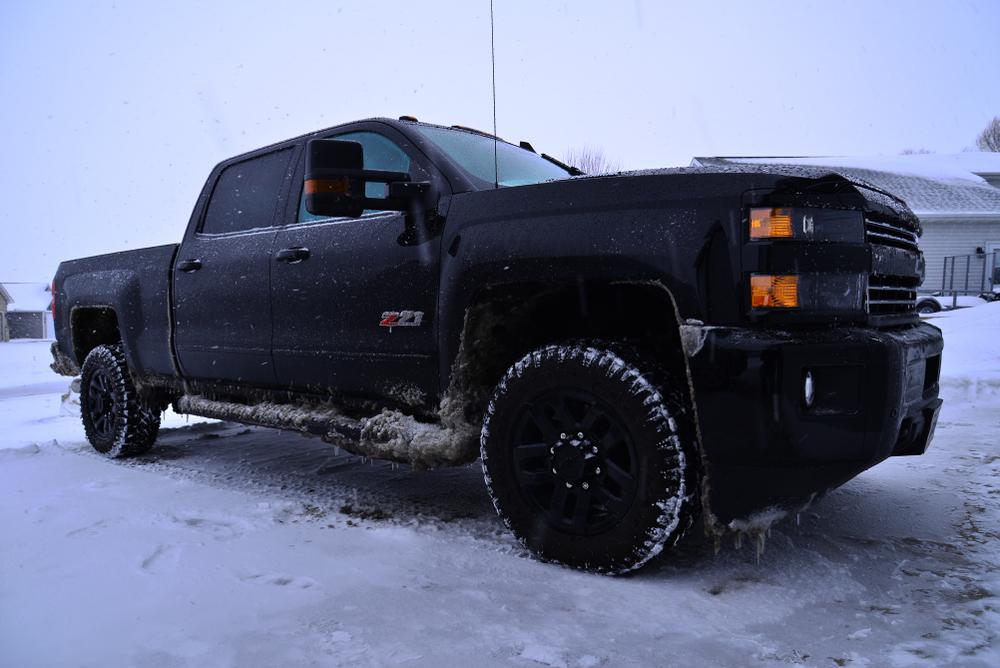 Ordfordville, Wisconsin / USA - February 17, 2019: 2019 Chevrolet Silverado 2500HD LTZ Midnight Edition Duramax  after a long winter drive on a very stormy day. 
