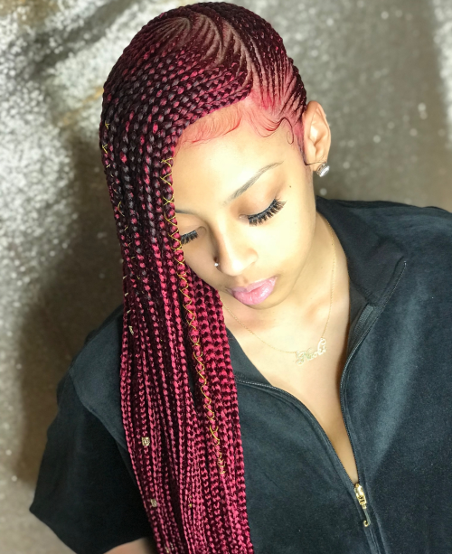 Picture showing  a lady rocking the red extension lemonade braids
