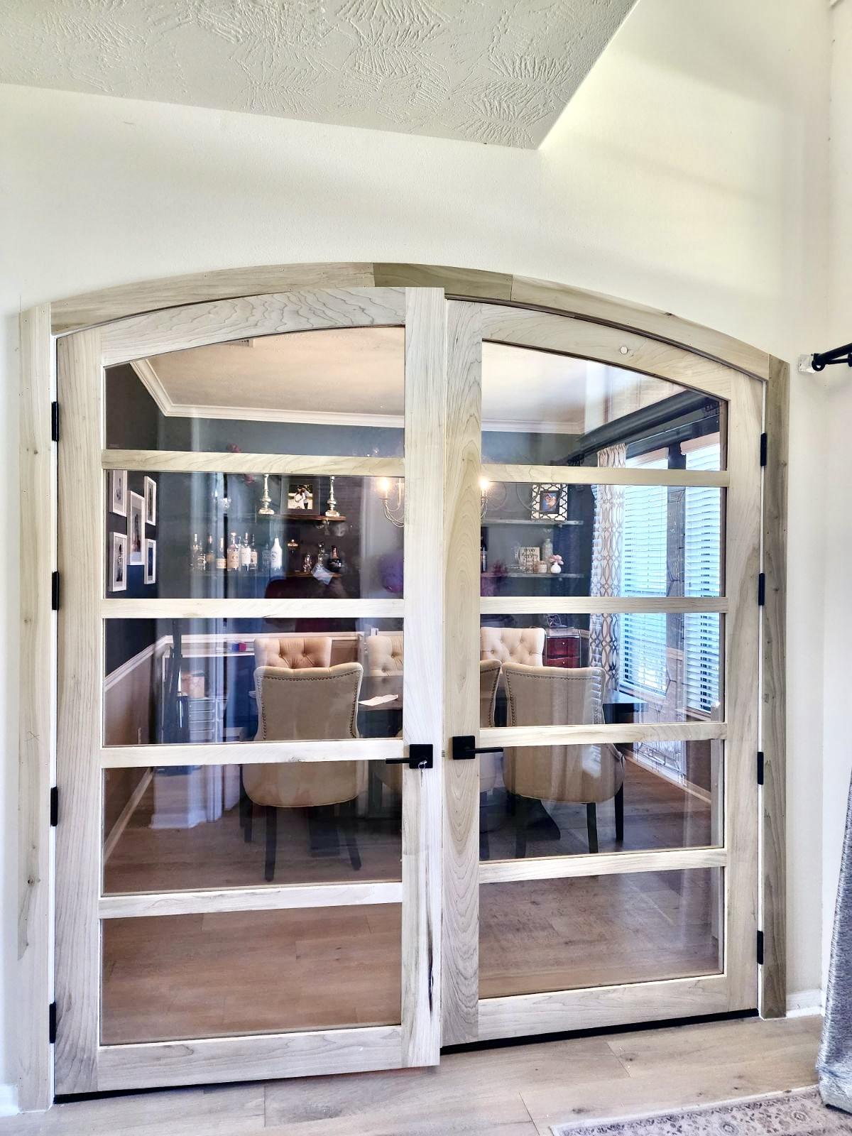 A glass door with a wood frame Description automatically generated