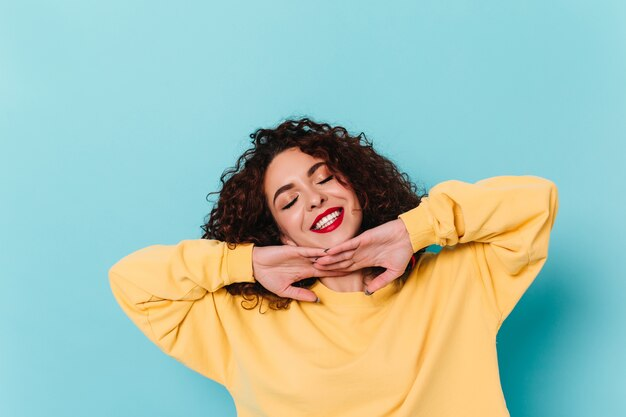 A woman in a joyful and happy mood with closed eyes.