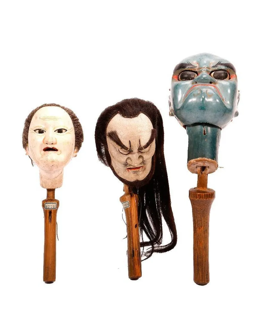 A group of masks on wooden sticksDescription automatically generated