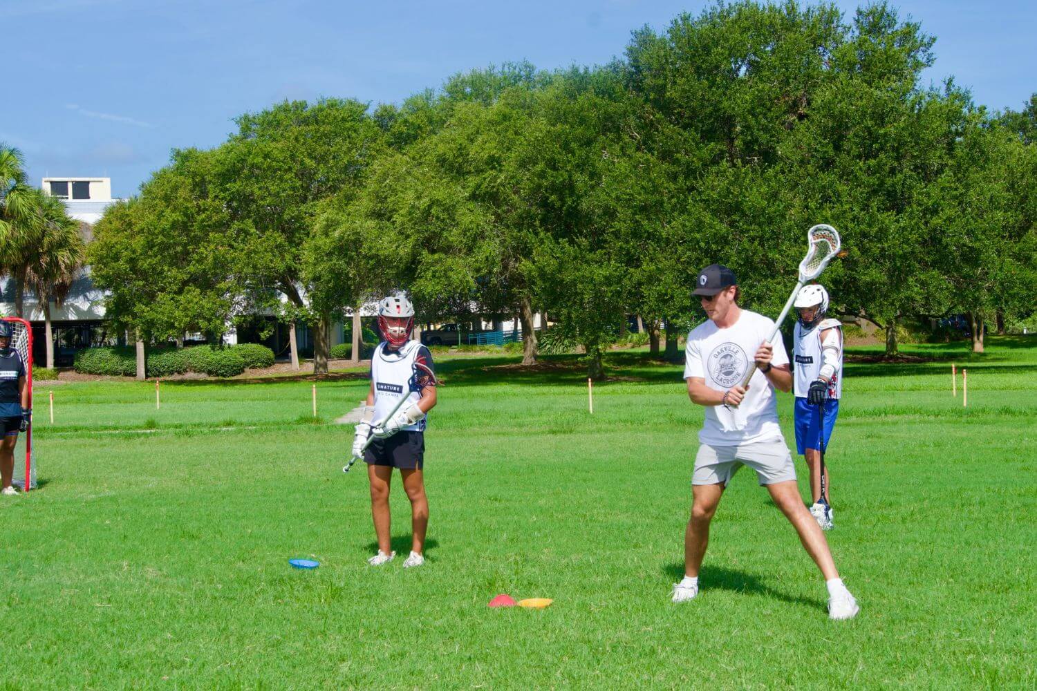 Professional lacrosse player giving instruction during lacrosse practice at overnight sports camp
