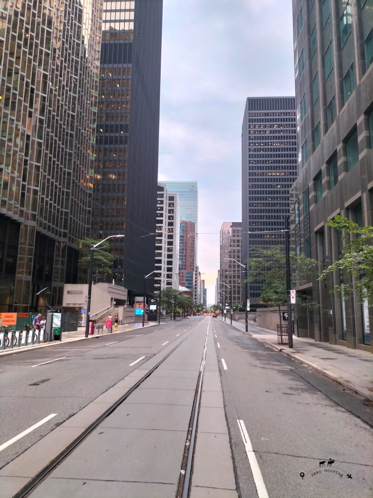 Image of Toronto Downtown deserted in the morning with the street in the center and tall skyscrapers on the sides.