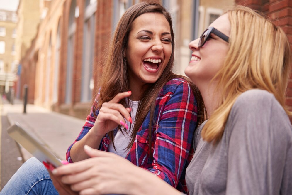 Two girls enjoying a moment of joyous laughter together.