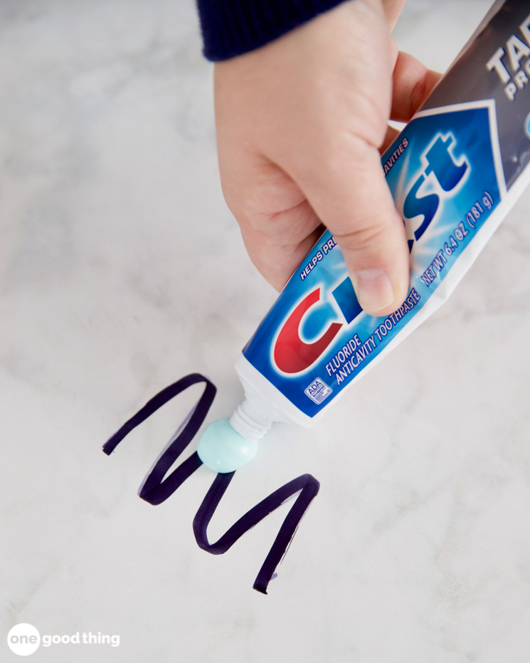 Photo showing removal of permanent marker using toothpaste.