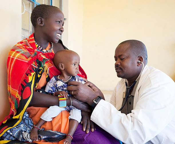 doctor examining maasai baby (12-23 months) - doctor kenya stock pictures, royalty-free photos & images