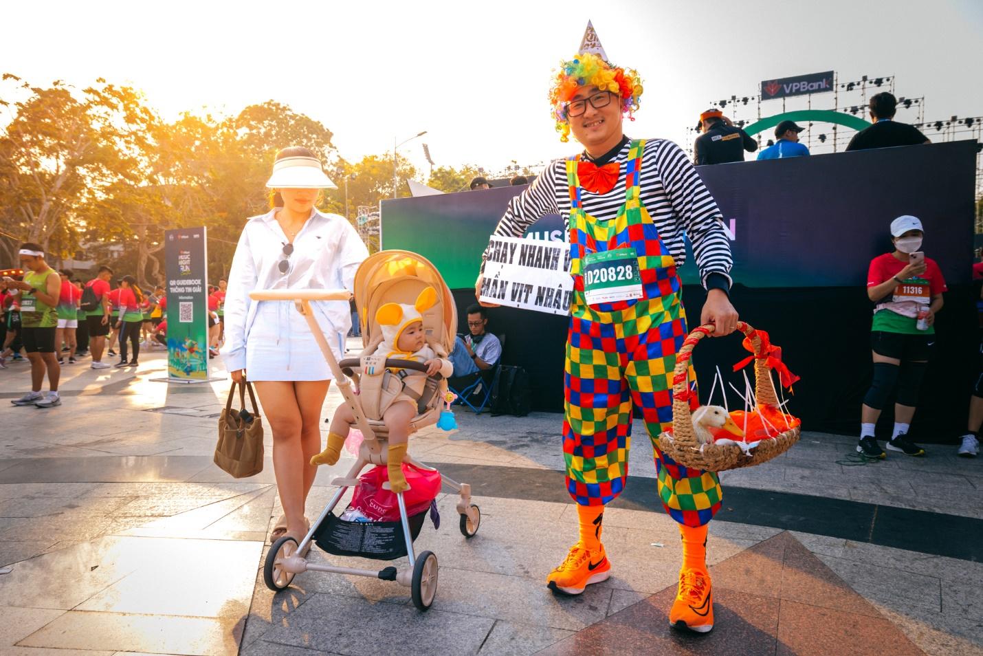A person in clown garment with a baby stroller and a person in a white coat

Description automatically generated