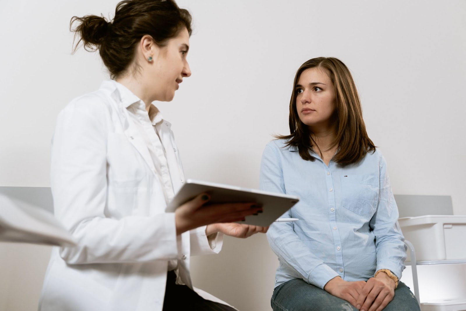 Healthcare office manager interacts with patient.