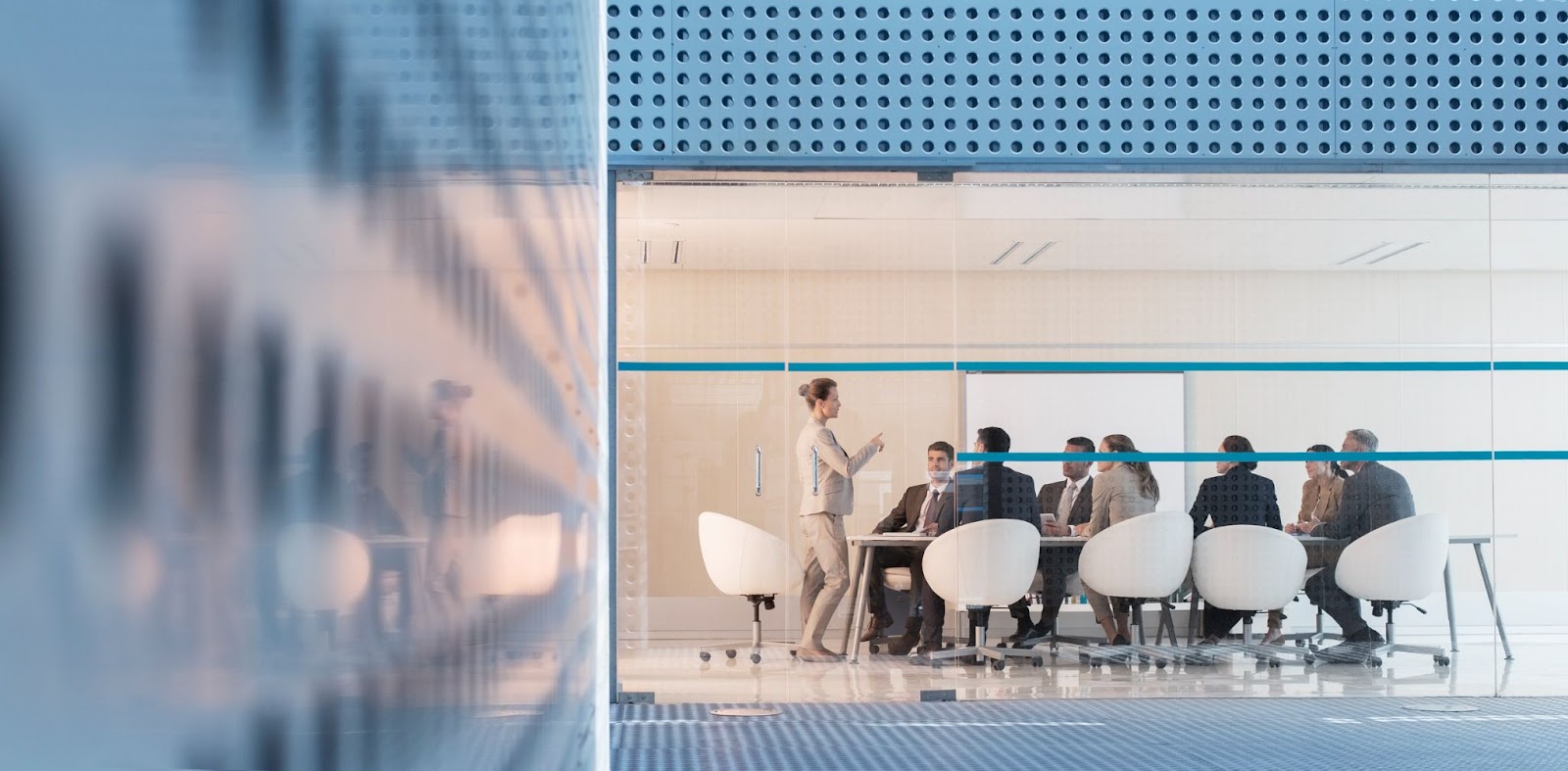 architect or engineer making a large client presentation in a conference room. 