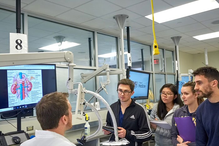 Medical students learning with equipment