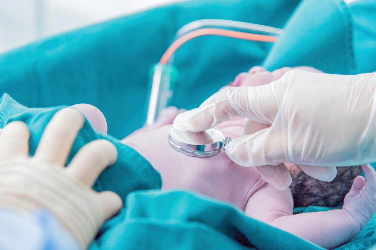  a pediatrician assessing a newborn