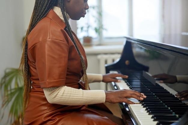 Woman learning to play the piano