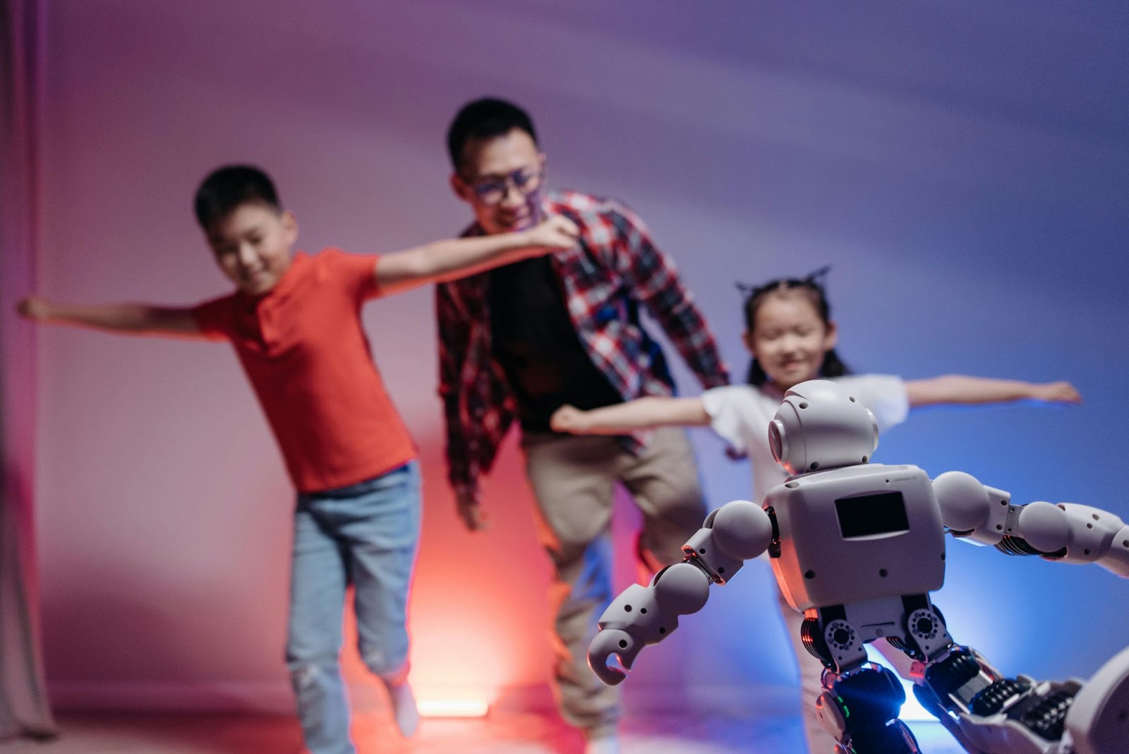 Hotel guests dancing with a robot.