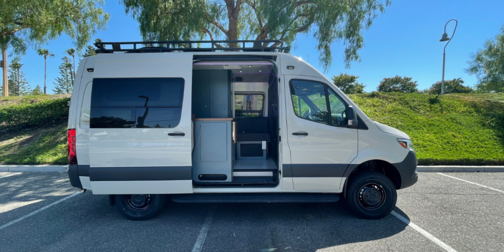 A sprinter campervan parked in a parking lot 