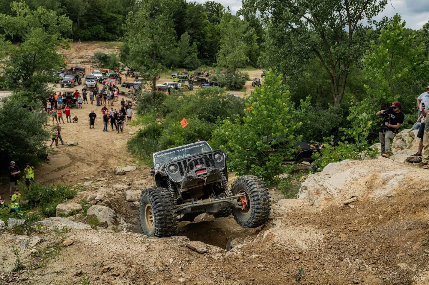 A jeep crawling a rock side at an off-road rally 