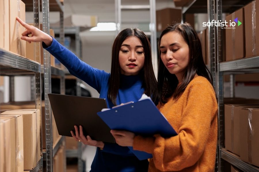 Two women examining inventory in a warehouse.