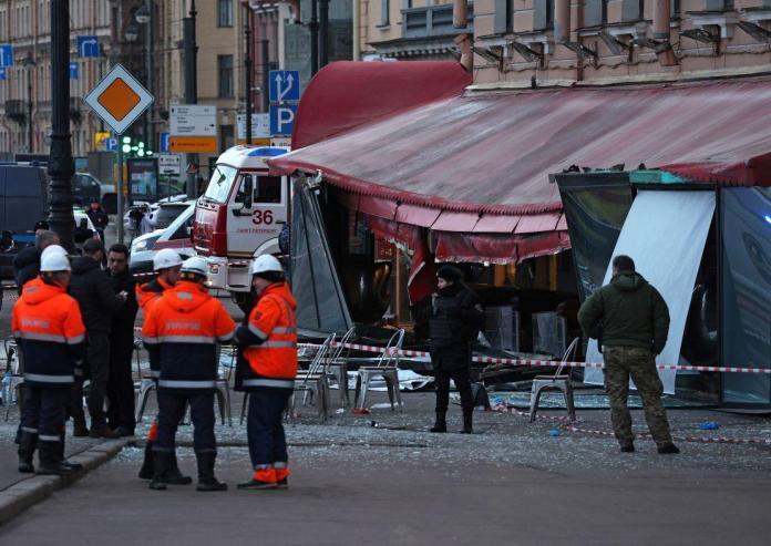 Investigators and members of emergency services work at the site of an explosion at a cafe in St. Petersburg, Russia on April 2, 2023. 