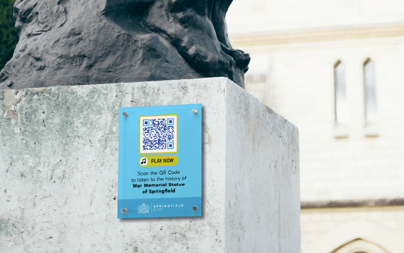 An MP3 QR Code on a historic statue prompting people to scan and listen to the history of the statue.