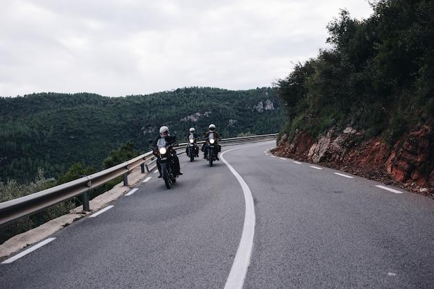 Free photo group of motorcycle riders on mountain road